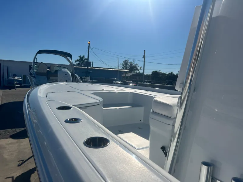 Slide: The Image of 2025 Contender 23 Bay boat, sleek design, sunny day, docked outdoors. - 6