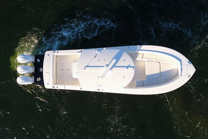 Slide: The Image of Aerial view of 2023 Regulator 34 boat cruising on water. - 12