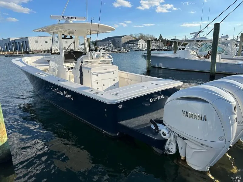 Slide: The Image of 2023 Regulator 34 boat docked, featuring Yamaha engines and Garmin equipment. - 13