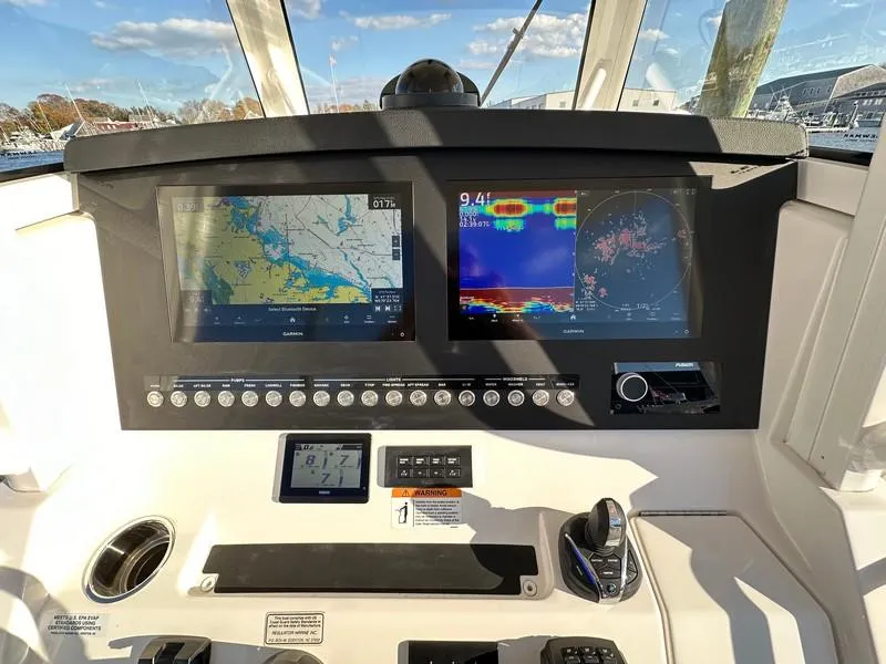 Slide: The Image of 2023 Regulator 34 boat dashboard with navigation and control screens. - 15