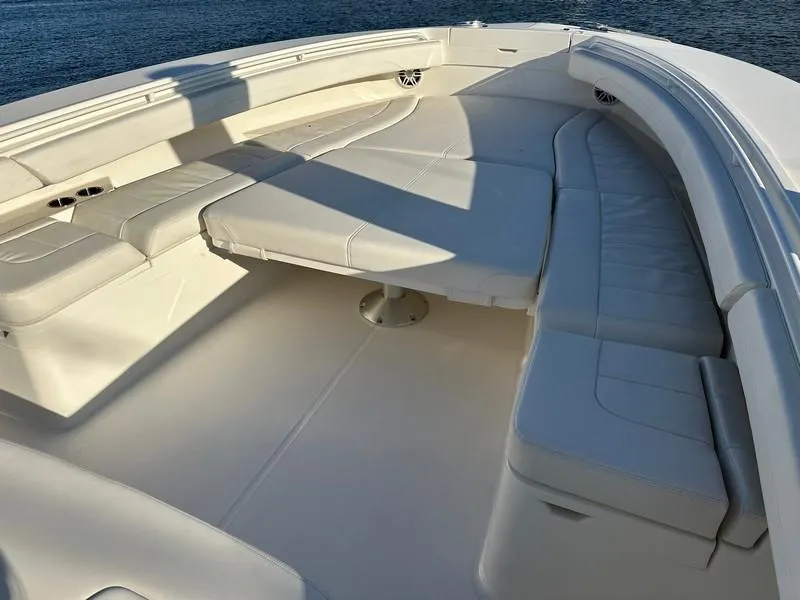 Slide: The Image of 2023 Regulator 34 boat with spacious white seating area on deck. - 18
