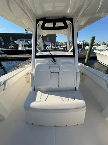Slide: The Image of 2023 Regulator 34 boat interior with seating, docked at marina. - 19