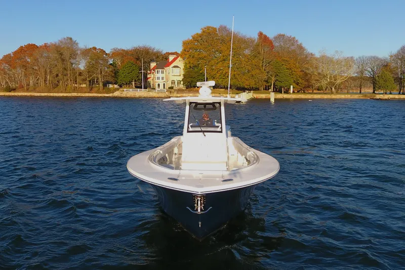 Slide: The Image of 2023 Regulator 34 boat on water near autumn shoreline. - 7