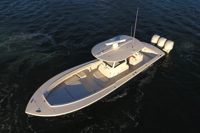 Slide: The Image of 2023 Regulator 34 boat on open water, featuring triple outboard engines. - 9