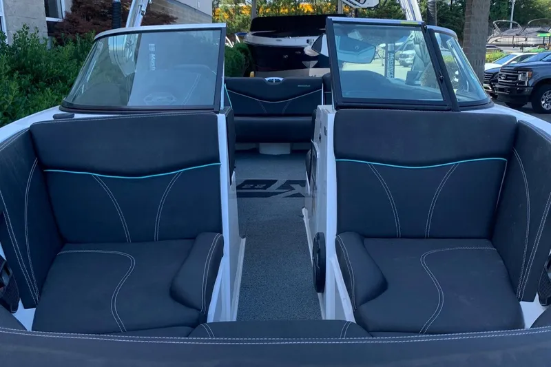 Slide: The Image of 2018 MasterCraft XT22 boat interior with black and blue seating. - 4