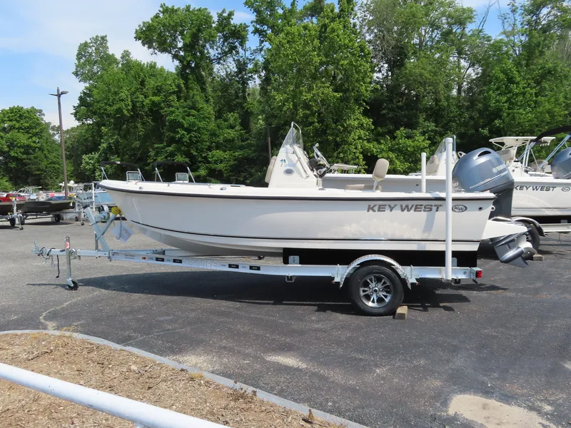 Slide: The Image of 2024 Key West 1720 Center Console boat on trailer, parked outdoors. - 1