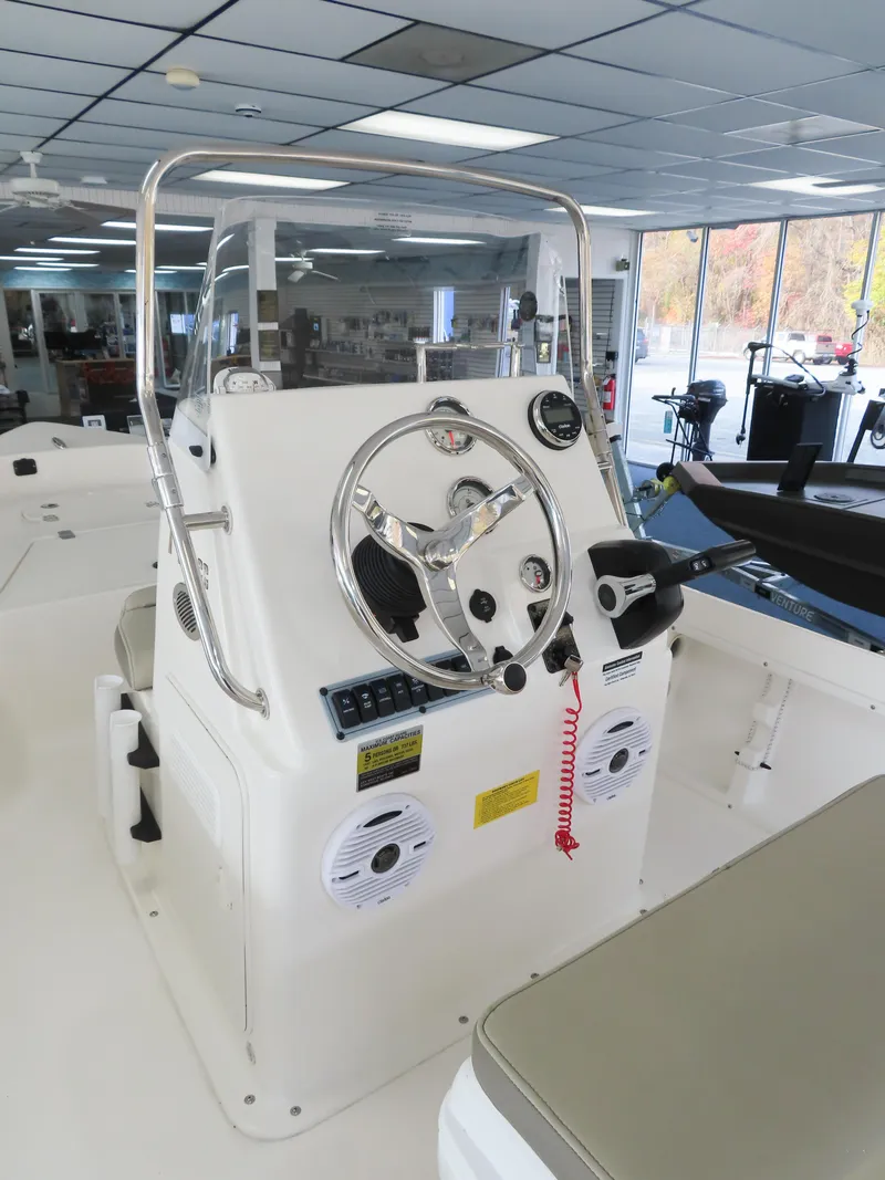 Slide: The Image of 2024 Key West 1720 Center Console boat interior with steering wheel and controls. - 7