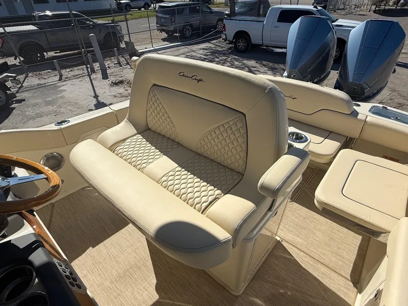 Slide: The Image of 2025 Chris-Craft Catalina 28 boat interior with beige seating and dual engines. - 12