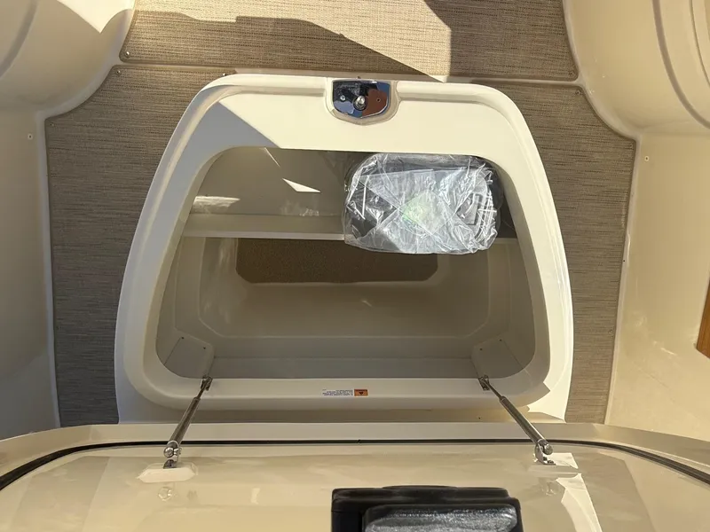 Slide: The Image of 2025 Chris-Craft Catalina 28 storage compartment with open hatch, showcasing interior space. - 16
