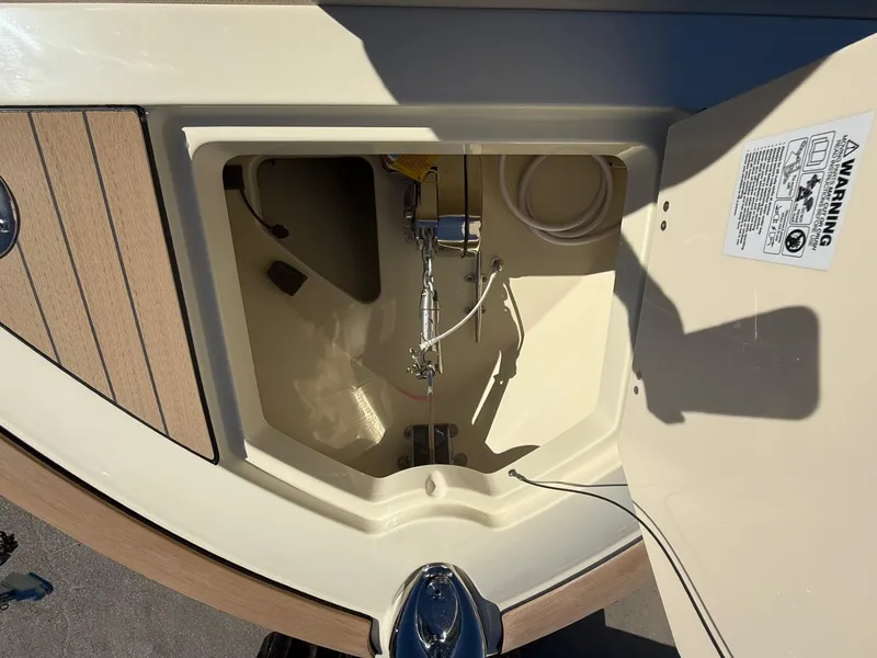 Slide: The Image of 2025 Chris-Craft Catalina 28 storage compartment with open hatch and visible interior details. - 18