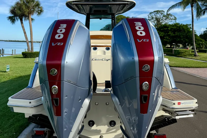 Slide: The Image of 2025 Chris-Craft Catalina 28 with dual Mercury 300 V8 outboard engines, docked by a scenic waterfront. - 7