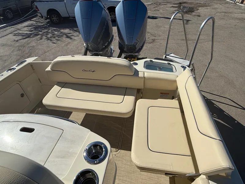 Slide: The Image of 2025 Chris-Craft Catalina 28 boat interior with beige seating and dual engines. - 9