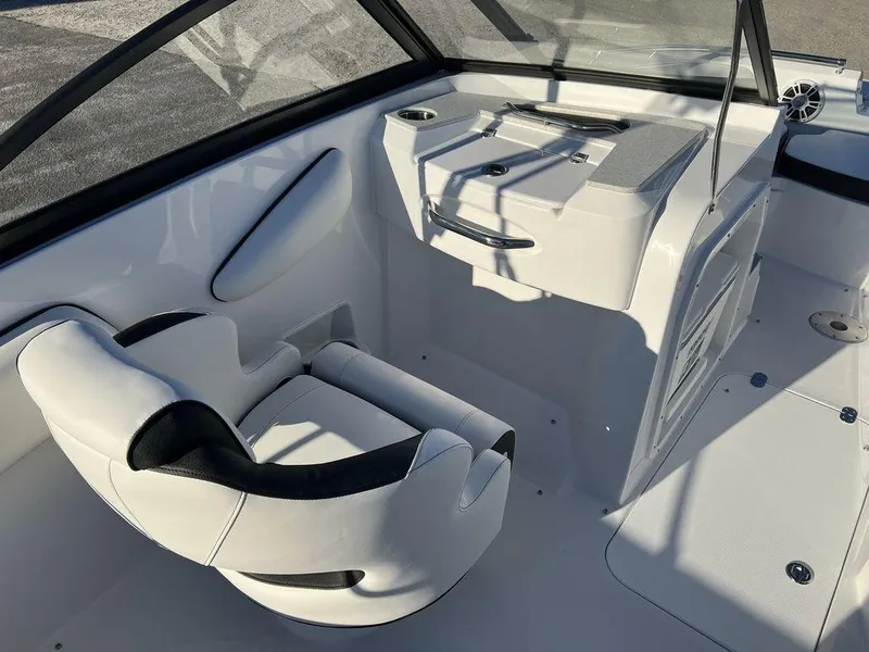 Slide: The Image of 2025 Stingray 201DC boat interior with white seating and sleek dashboard design. - 13