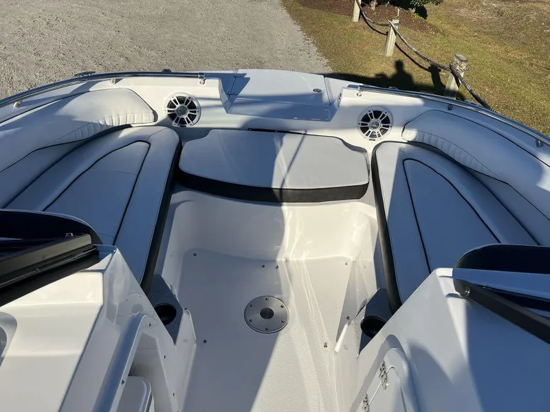 Slide: The Image of Interior of 2025 Stingray 201DC boat with white seating and speakers. - 14