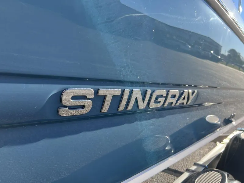 Slide: The Image of 2025 Stingray 201DC boat logo on sleek blue exterior. - 15