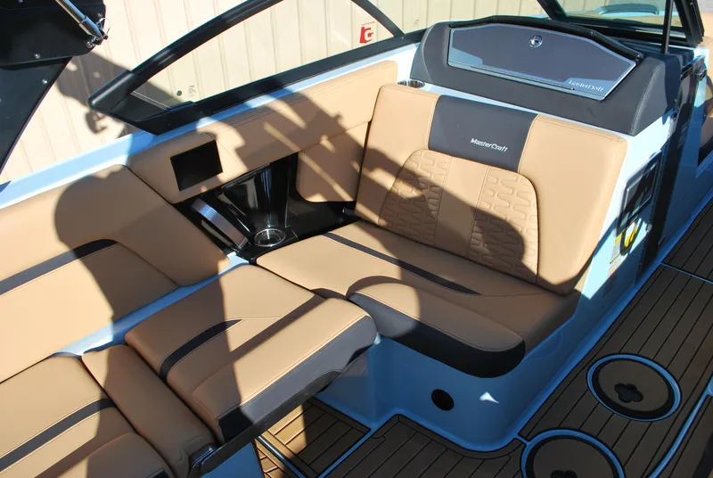 Slide: The Image of 2022 MasterCraft X24 boat interior with tan seating and sleek design. - 10