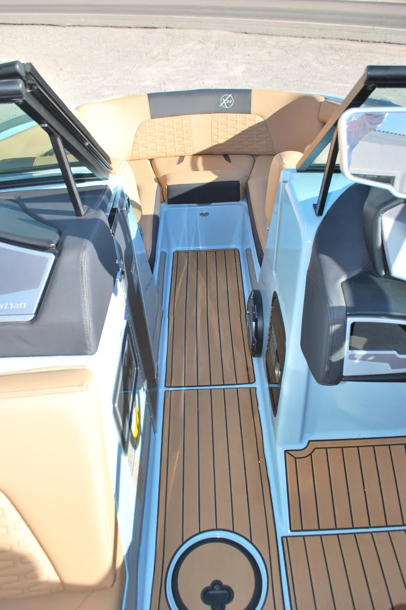 Slide: The Image of 2022 MasterCraft X24 boat interior with teak flooring and modern seating. - 11