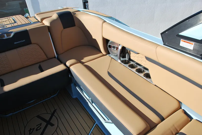 Slide: The Image of Luxurious interior of 2022 MasterCraft X24 boat with tan leather seating and cup holders. - 14