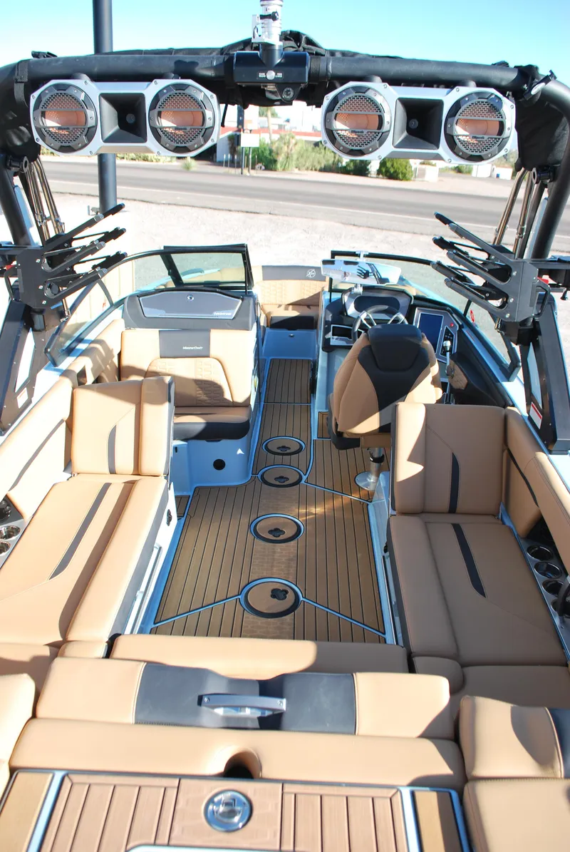 Slide: The Image of 2022 MasterCraft X24 boat interior with tan seating and sleek design. - 17