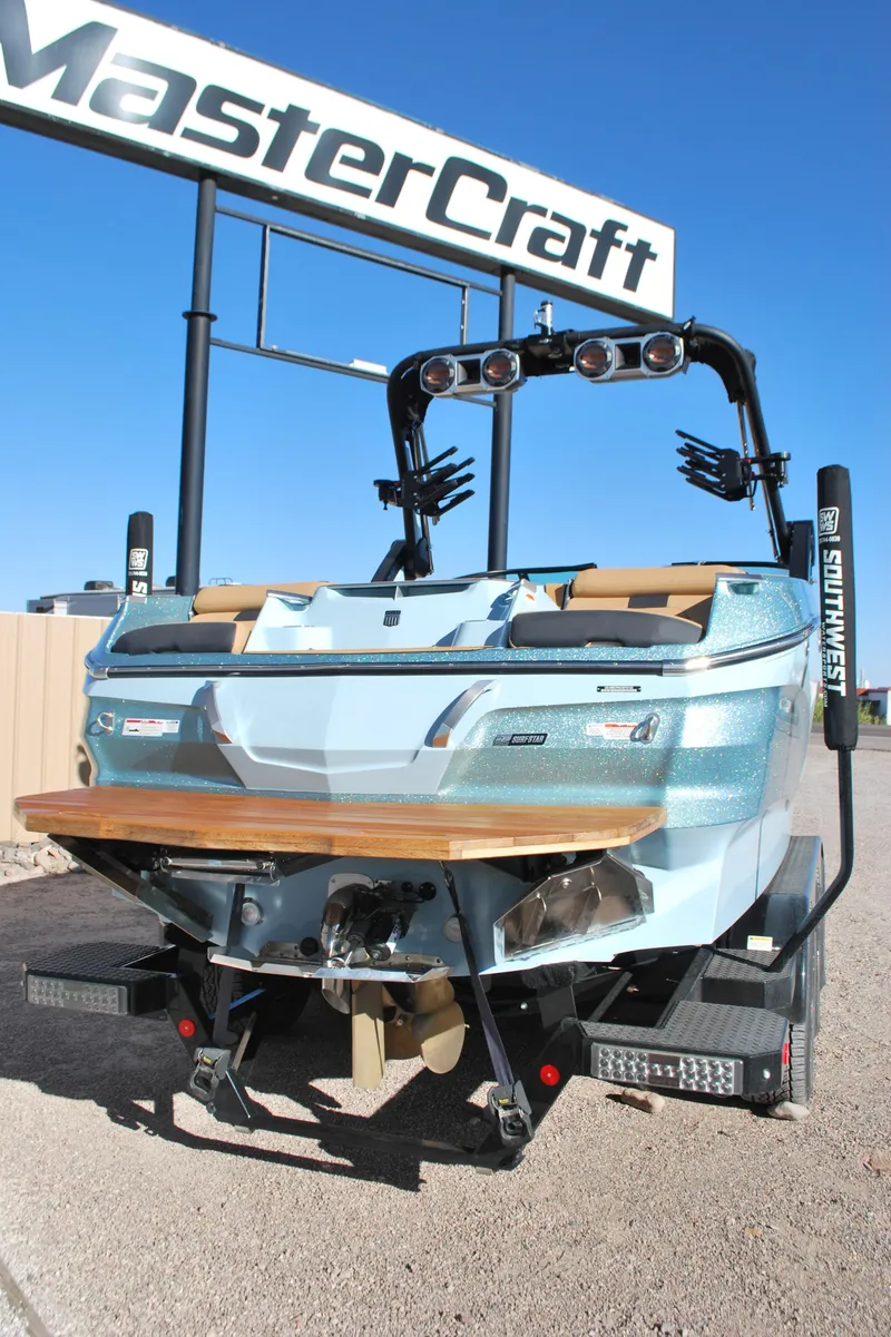 Slide: The Image of 2022 MasterCraft X24 boat displayed outdoors under clear blue sky. - 20