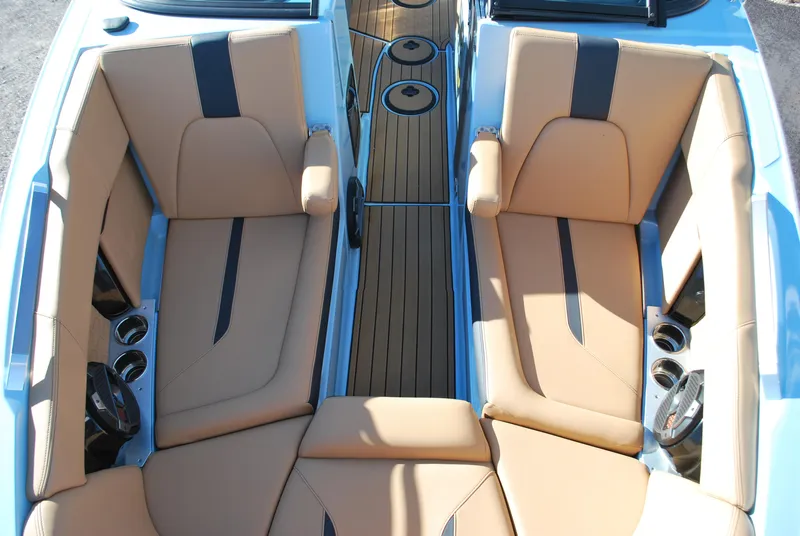 Slide: The Image of 2022 MasterCraft X24 boat interior with tan leather seats and sleek design. - 5