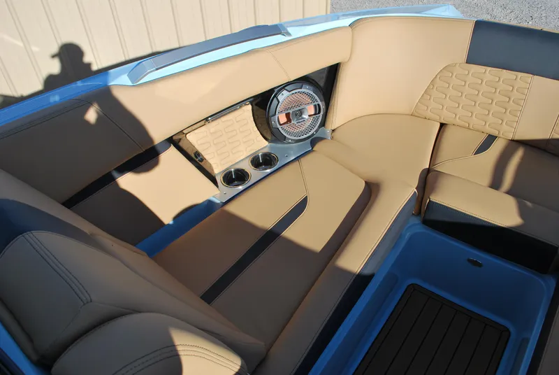 Slide: The Image of 2022 MasterCraft X24 boat interior with tan leather seating and built-in speakers. - 6