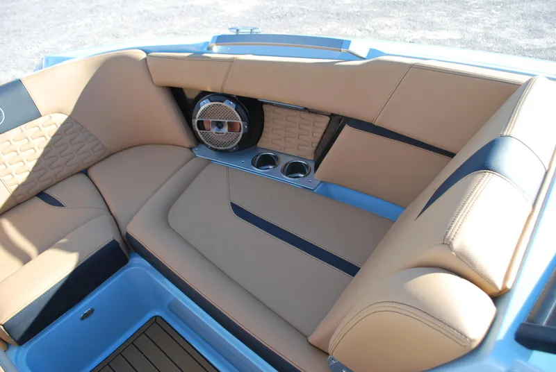 Slide: The Image of 2022 MasterCraft X24 boat interior with tan leather seating and built-in speakers. - 7