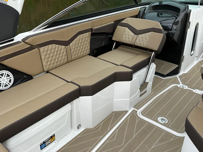 Slide: The Image of 2025 Monterey 258SS boat interior with tan and brown seating, modern design. - 12
