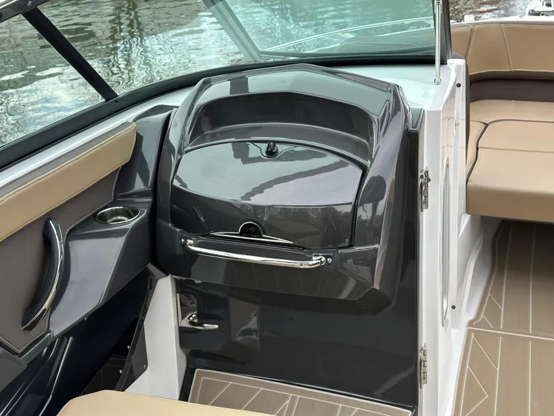 Slide: The Image of 2025 Monterey 258SS boat interior with sleek dashboard and beige seating. - 14
