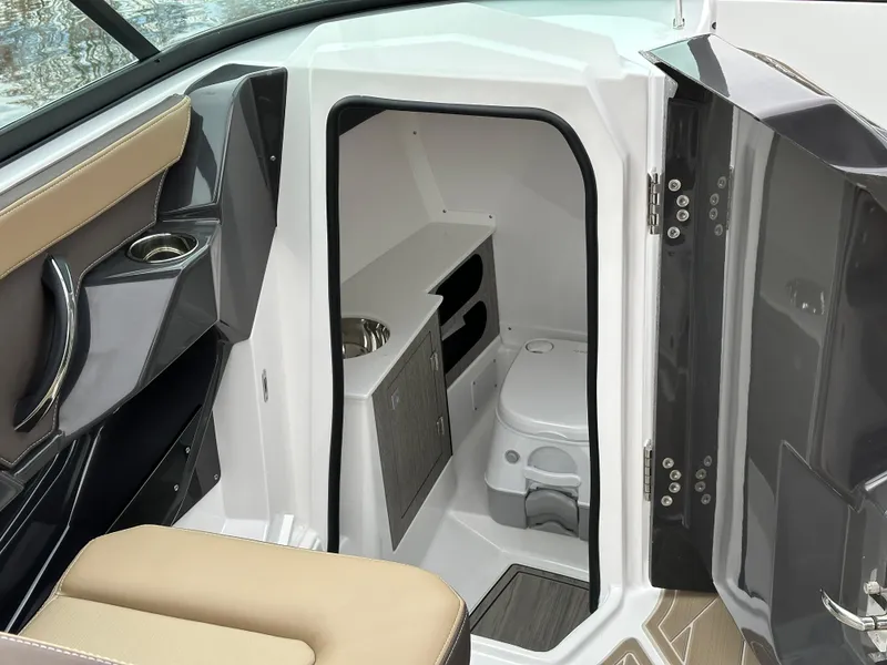 Slide: The Image of 2025 Monterey 258SS boat interior with compact bathroom and modern design. - 15