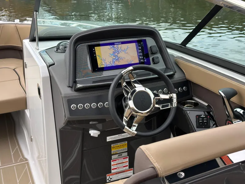 Slide: The Image of 2025 Monterey 258SS boat dashboard with modern steering and navigation display. - 16