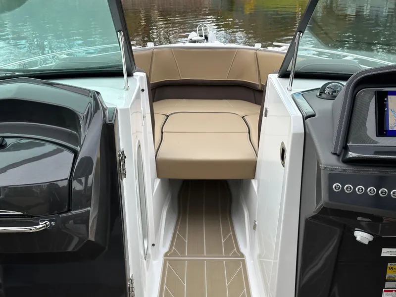 Slide: The Image of Interior view of 2025 Monterey 258SS boat with tan seating and modern dashboard. - 17