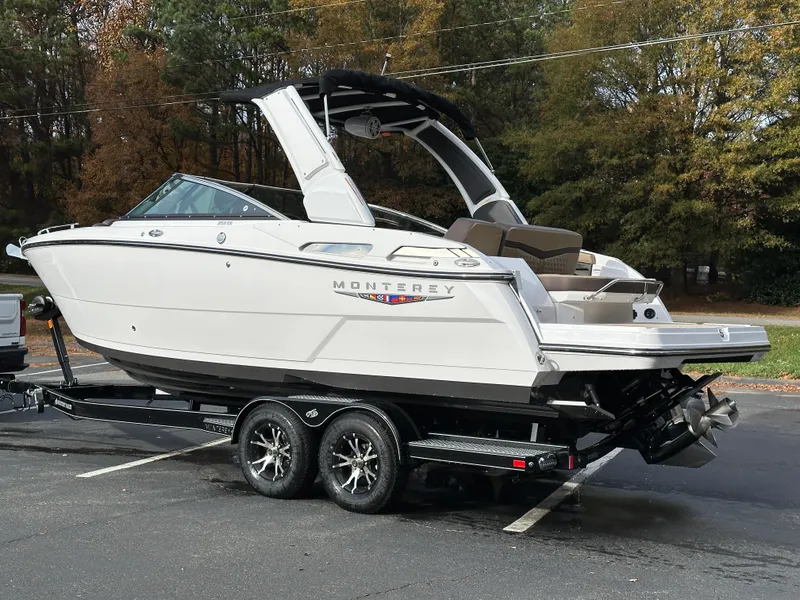 Slide: The Image of 2025 Monterey 258SS boat on trailer, parked outdoors. - 26