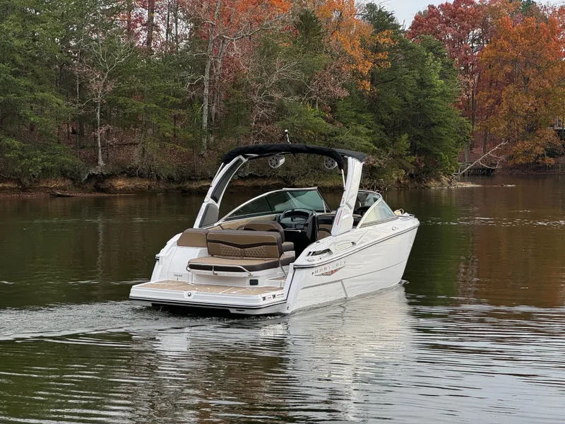 Slide: The Image of 2025 Monterey 258SS boat cruising on a serene lake with autumn foliage. - 4