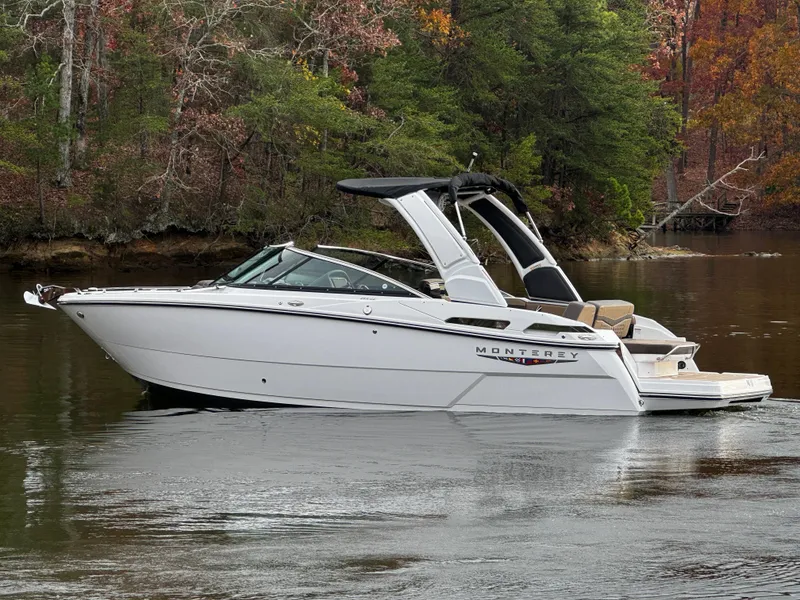 Slide: The Image of 2025 Monterey 258SS boat on a calm lake with autumn trees in the background. - 5