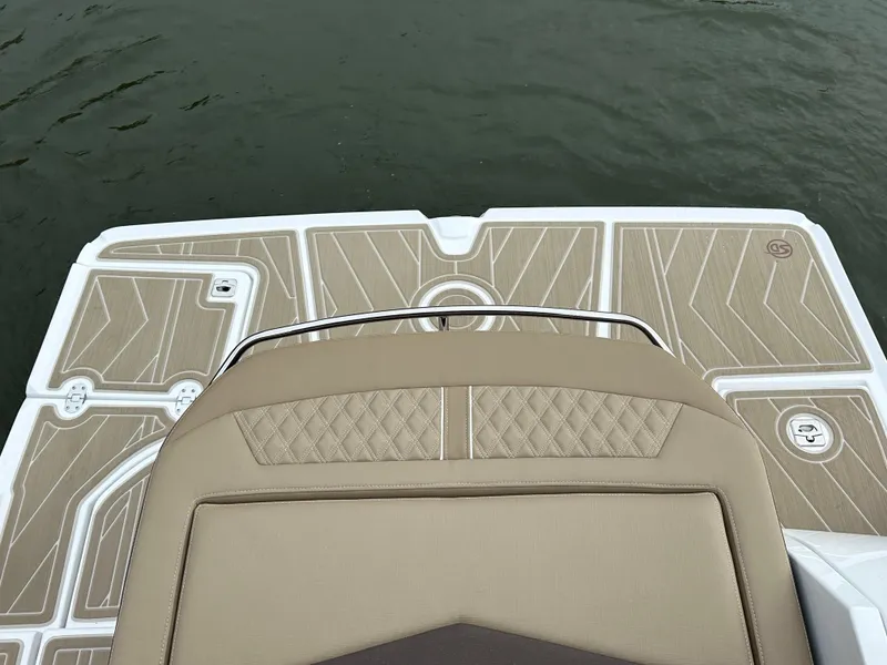 Slide: The Image of 2025 Monterey 258SS boat deck with beige cushioned seating and stylish flooring design. - 7