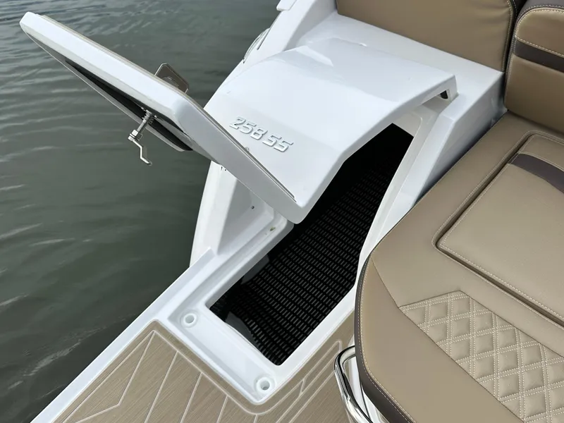 Slide: The Image of 2025 Monterey 258SS boat with open storage compartment and cushioned seating. - 8