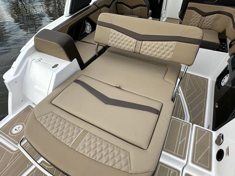 Slide: The Image of 2025 Monterey 258SS boat interior with beige and brown seating, elegant design. - 9