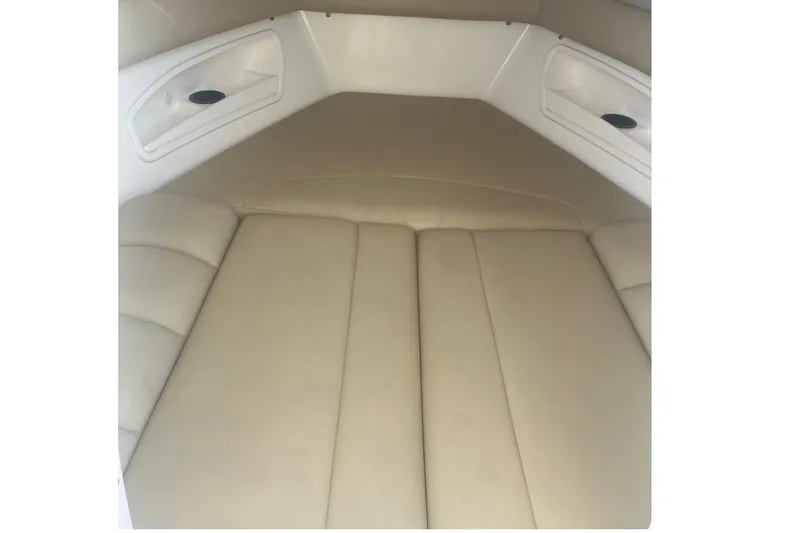 Slide: The Image of 2008 Boston Whaler 320 Outrage Cuddy Cabin interior with beige cushions. - 16