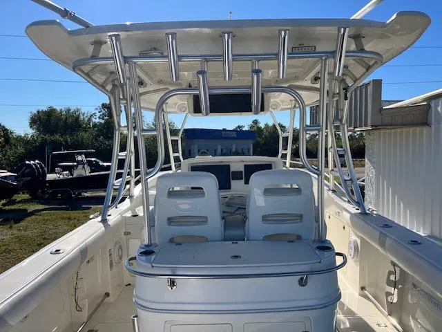 Slide: The Image of 2016 Boston Whaler 320 Outrage Cuddy Cabin boat interior with seating and rod holders. - 3