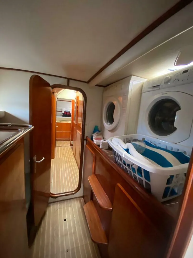 Slide: The Image of Laundry area inside 1993 Privilege Boolean yacht with washer, dryer, and basket. - 10