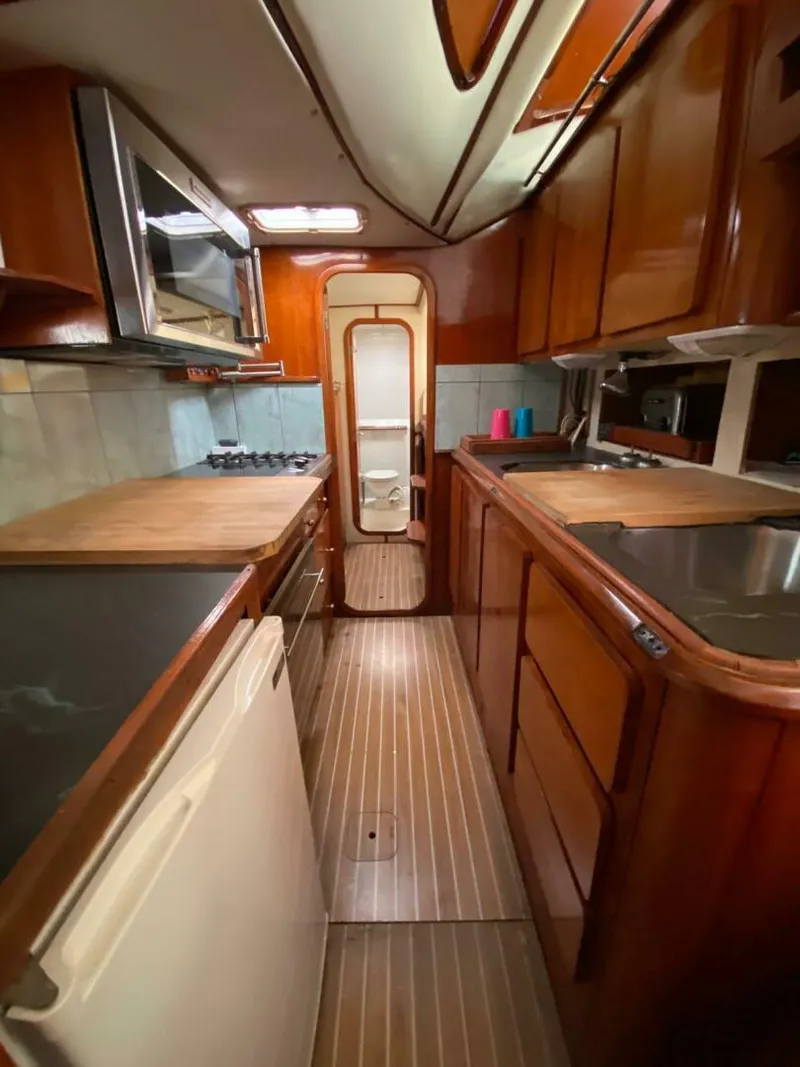 Slide: The Image of 1993 Privilege Boolean yacht kitchen with wooden cabinetry and modern appliances. - 12