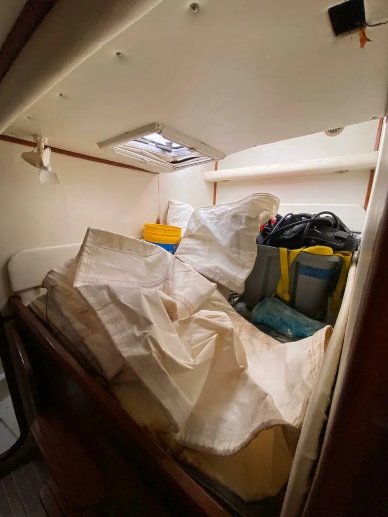 Slide: The Image of Interior of a 1993 Privilege Boolean boat with storage items and equipment. - 14