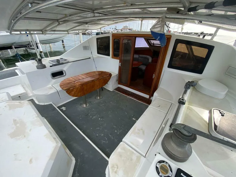 Slide: The Image of Spacious 1993 Privilege Boolean yacht deck with seating and wooden table. - 4