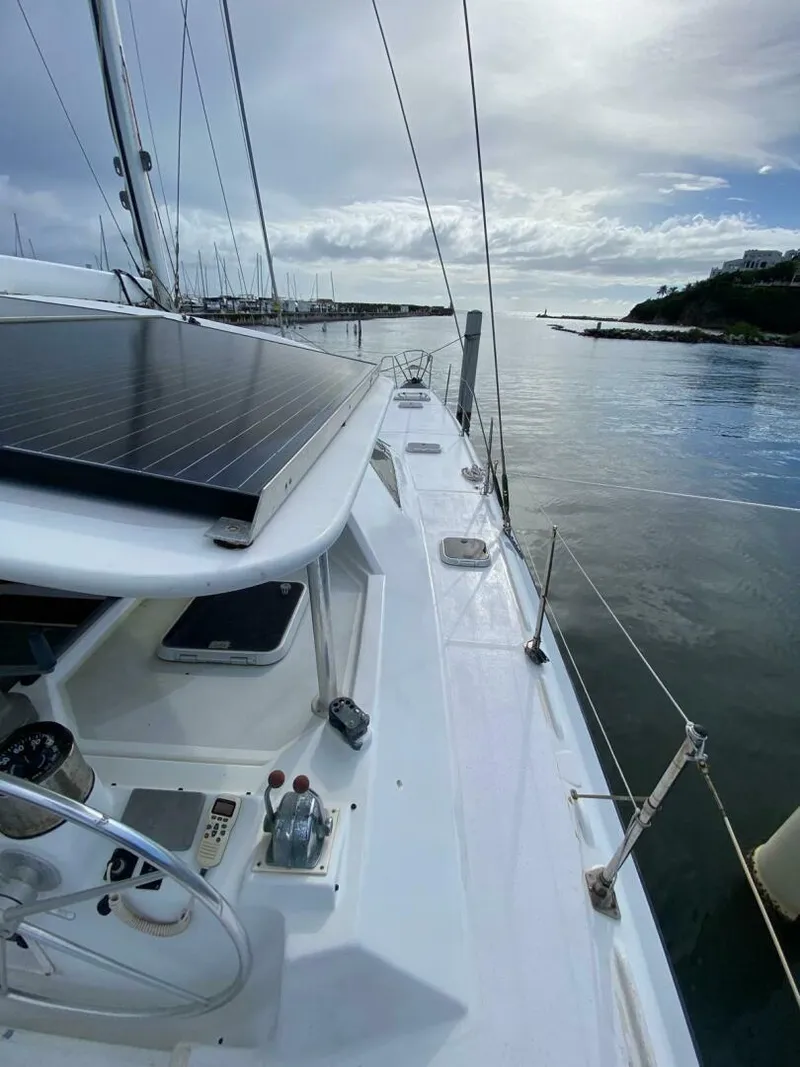 Slide: The Image of Sailing yacht "Privilege Boolean" 1993 model docked by calm waters under a cloudy sky. - 5