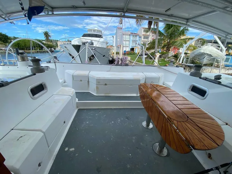 Slide: The Image of Spacious deck of 1993 Privilege Boolean yacht with seating and wooden table. - 6