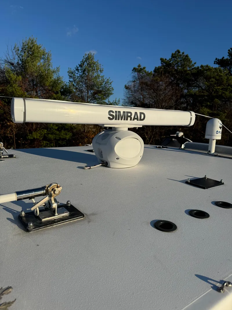 Slide: The Image of Simrad radar on 2022 Invincible 40 Catamaran under clear blue sky. - 12