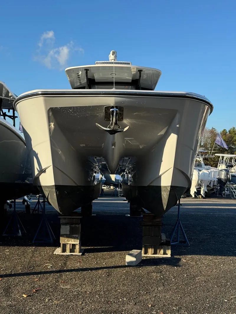 Slide: The Image of 2022 Invincible 40 Catamaran on display, front view under clear blue sky. - 19