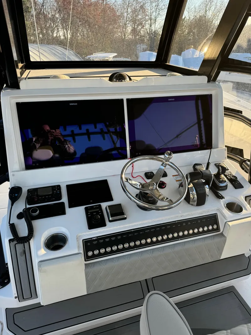Slide: The Image of 2022 Invincible 40 Catamaran helm with dual screens and modern controls. - 20