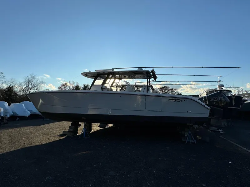 Slide: The Image of 2022 Invincible 40 Catamaran on land, side view, under clear blue sky. - 3